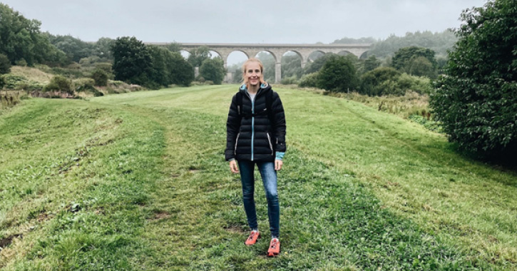 blogger Melissa Marshall smiling at camera with Newton Cap Viaduct in background, Bishop Auckland.